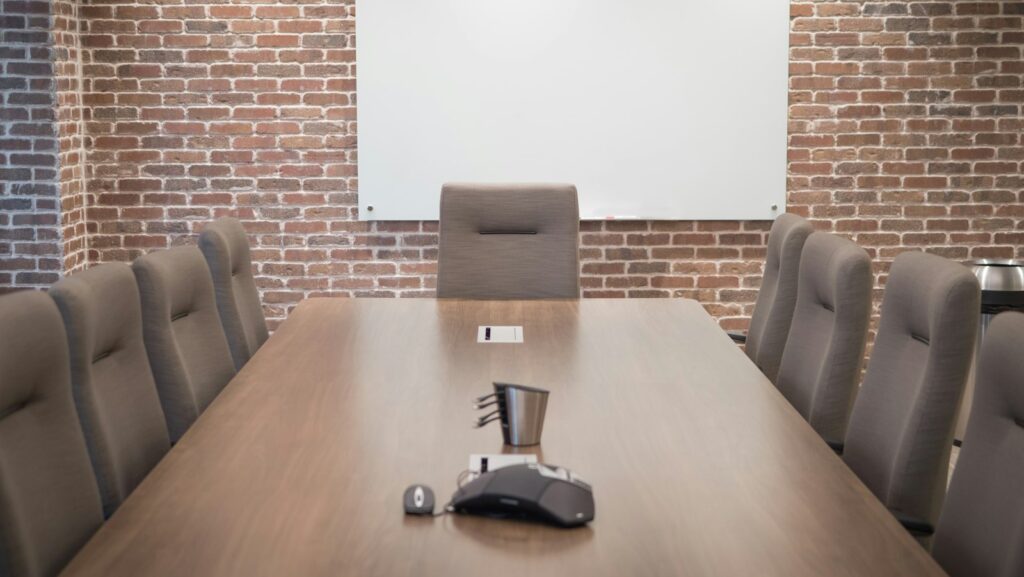 Modern conference room with a projector screen, a large table and chairs